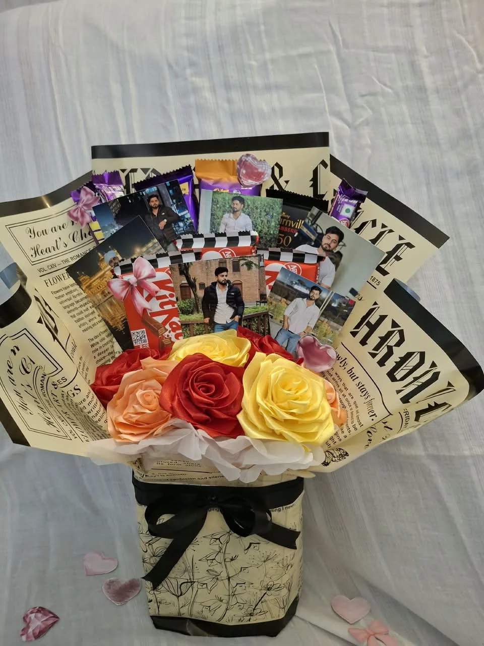 Handcrafted bouquet of satin blooms in newspaper wrapper